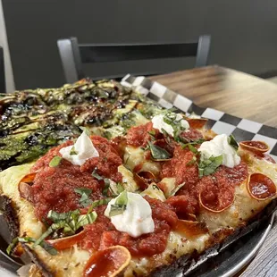 They do 1/2 &amp; 1/2 pizzas that are on the same crust. This is a Detroit style 1/2 pesto, 1/2 classic w/ extra basil. 5/5. July 2022.