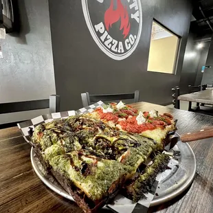 They do 1/2 &amp; 1/2 pizzas that are on the same crust. This is a Detroit style 1/2 pesto, 1/2 classic w/ extra basil. 5/5. July 2022.