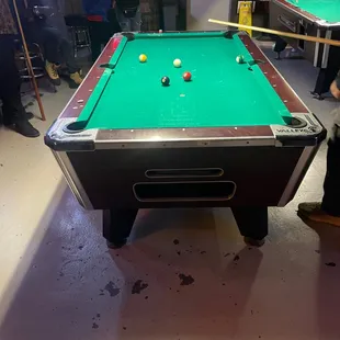 a pool table in the middle of the room