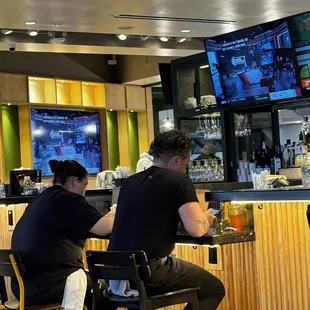 two people sitting at the bar