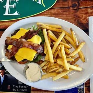 The Texan 1/2 lb Burger with bacon, cheese, pickles, tomatoes, onion and lettuce.