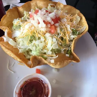 a taco salad in a tortilla bowl