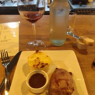 Duck a l' orange with glass of mourvedre