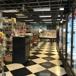 View inside the store.  Meat case straight ahead, refrigerated items to the right.