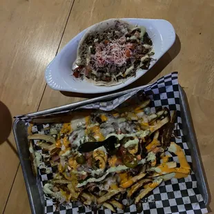 a plate of nachos and a bowl of salad