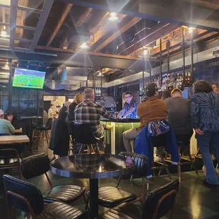 a group of people sitting at a bar