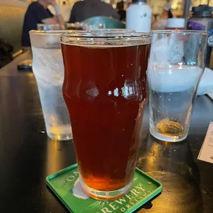 a pint of beer on a coaster