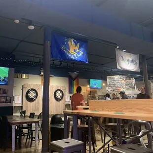 The dart board, the cool flags, and some of the high top seating.
