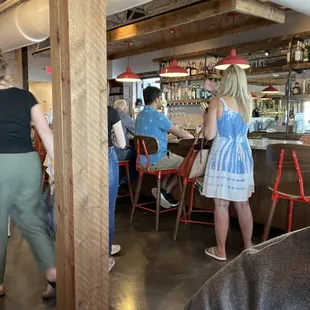 a group of people sitting at a bar