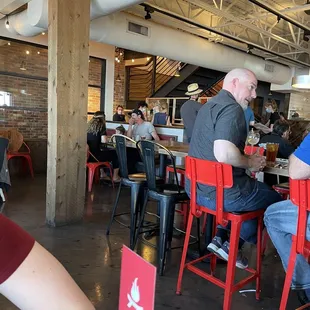 a group of people sitting at tables in a restaurant