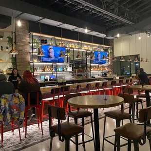 people sitting at the bar in a restaurant