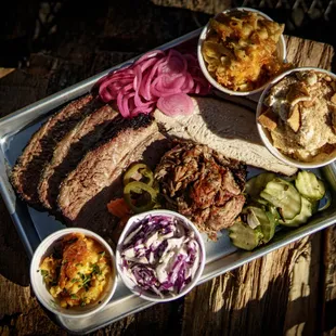 a platter of meat and sides