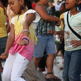 two young girls dancing on the street