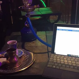 a laptop and a hooket on a table