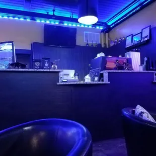 a bar with purple lighting