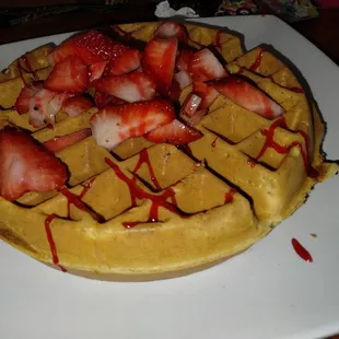 Chicken and waffles , waffle with strawberry's.
