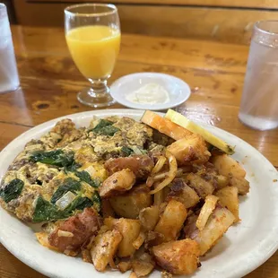 a plate of food and a glass of orange juice