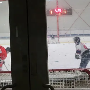 Surprising to watch a hockey game from the sidewalk in Uptown Oakland at midnight on a Thursday.