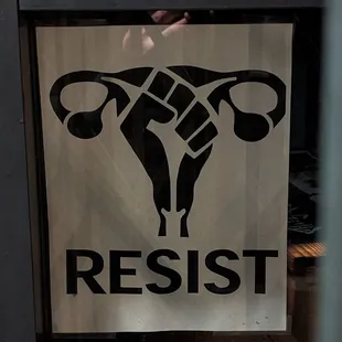 a resist sign in a window