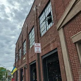 a brick building with a no parking sign
