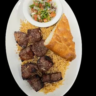 Beef Kabob with golden rice, salata(chopped salad) and naan.