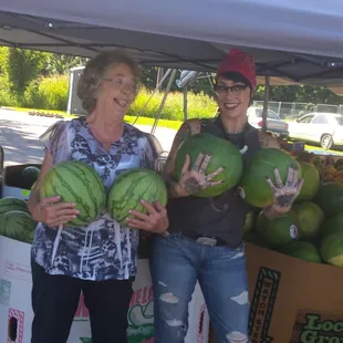 two women holding watermelons