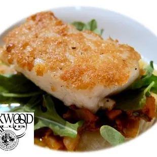 a white plate with a fish dish on it