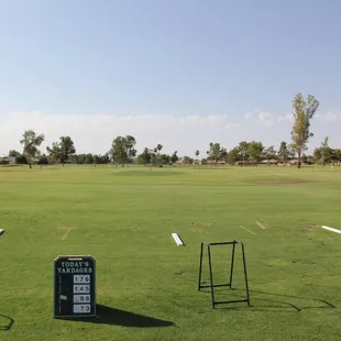 a scoreboard in the middle of a golf course