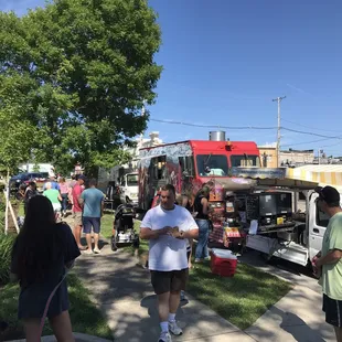  a group of people standing in front of a food truck