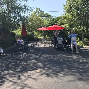  a group of people sitting under an umbrella
