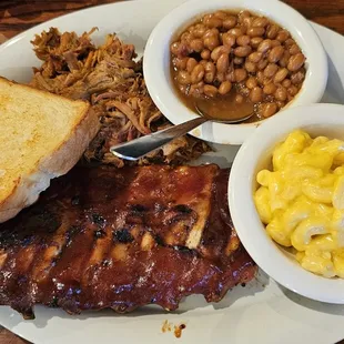 Ribs, pulled pork, Texas toast garlic bread, baked beans, and macaroni and cheese