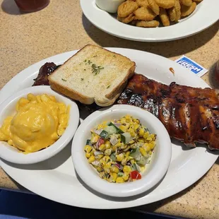 The best ribs! Macaroni &amp; cheese, roasted corn salad, garlic bread &amp; fried pickles.