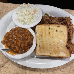 Pulled Pork with garlic Texas toast,  Sam&apos;s Slaw, baked beans
