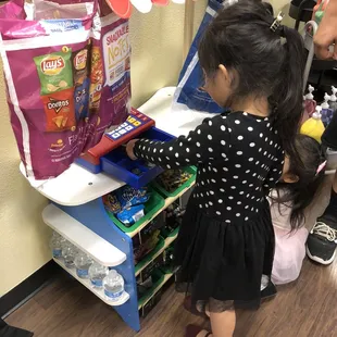 My daughter buying candy with her art dollar.