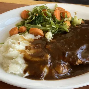 Chicken fried steak, veggies and I swear these are mashed potato flakes from a box?