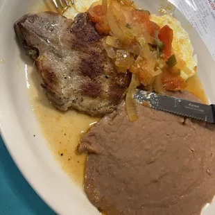 Huevos rancheros with a pork chop