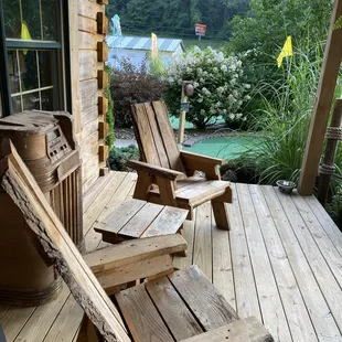 two wooden chairs on a porch
