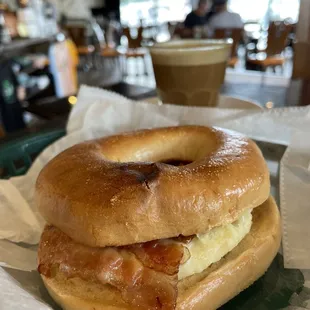 a bagel sandwich with bacon and eggs