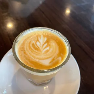 a latte in a glass cup