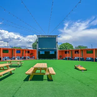 a large screen and picnic tables