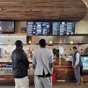 two men standing in front of the counter