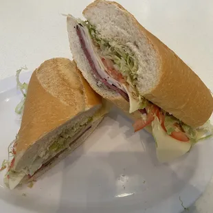 The East Sider Sandwich 
Turkey, Pastrami, Swiss cheese, lettuce, Tomatoes, Onions, Oil &amp; vinegar, Creamy Garlic Mayo, Oasis Dressing.