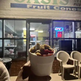a person holding a bowl of fruit