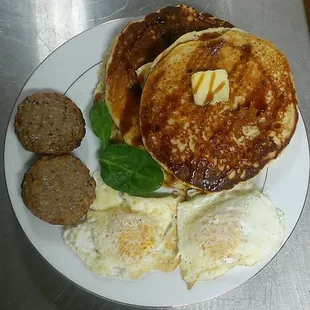 Gluten free Hemp, Coconut, and Banana Pancakes with secret syrup, 2 eggs, and sausage. Saturday's brunch special!