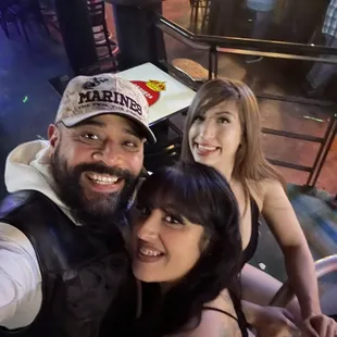 a man and two women taking a selfie