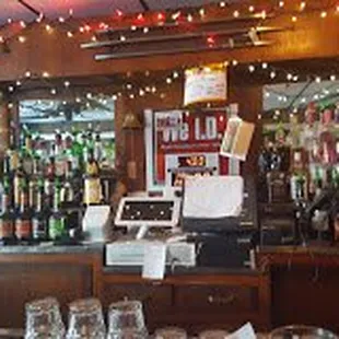 a bar with a lot of bottles and glasses