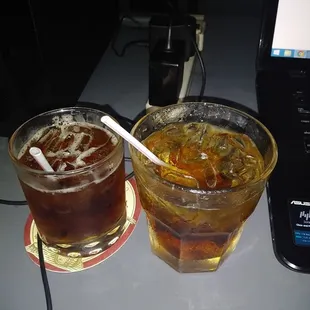 two glasses of soda and a drink