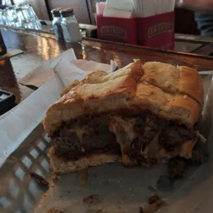 a half eaten sandwich on a tray