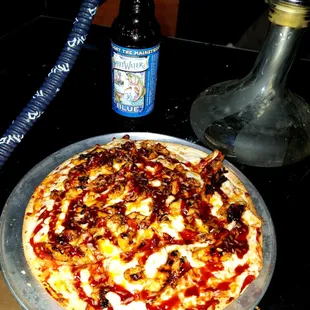 a pizza and a bottle of beer