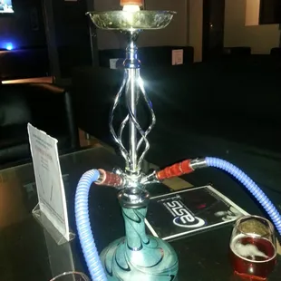 a hook smoking a glass of wine